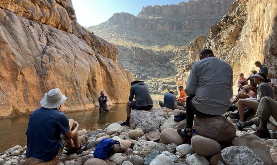 Discussing geology by the water in the Grand Canyon